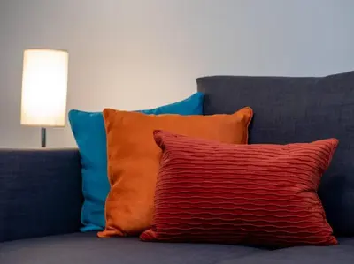 a red pillow sitting on top of a couch at Luxury Townhome in Heart of Over the Rhine in Cincinnati
