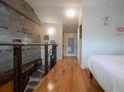 a room with a bed and a brick wall at Spacious Suites in OTR - Findlay Market in Cincinnati