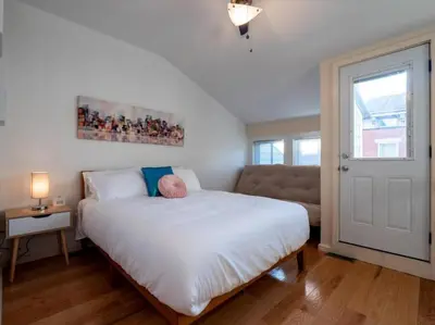 a bedroom with a large white bed and a couch at Spacious Suites in OTR - Findlay Market in Cincinnati