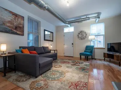 a living room with a couch and a television at Spacious Suites in OTR - Findlay Market in Cincinnati