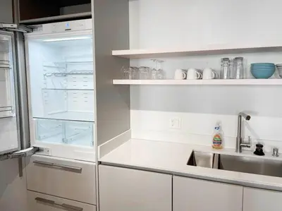 a kitchen with an empty refrigerator and a sink at Findlay Suites - Perfect Location Over the Rhine in Cincinnati