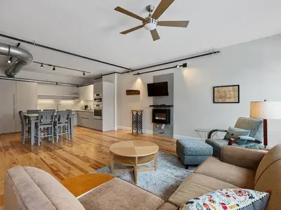 a living room with a couch and a table at Findlay Suites - Perfect Location Over the Rhine in Cincinnati