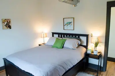 a bedroom with a large bed with green pillows at Stunning Condos Near Washington Park w Parking in Cincinnati