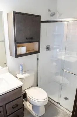a bathroom with a toilet and a glass shower at Stunning Condos Near Washington Park w Parking in Cincinnati