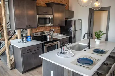 a kitchen with stainless steel appliances and a counter top at Stunning Condos Near Washington Park w Parking in Cincinnati