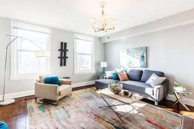 a living room with a blue couch and chairs at Spacious Home Walk to Everything and FREE Parking in Cincinnati