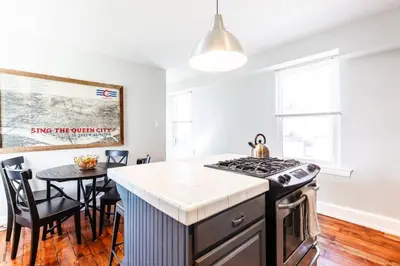 a kitchen with a stove and a table with chairs at Spacious Home Walk to Everything and FREE Parking in Cincinnati