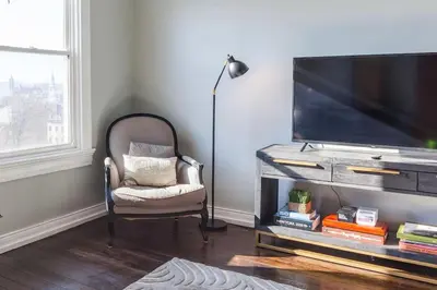 a living room with a tv and a chair at OTR Penthouse Walk Everywhere FREE Parking in Cincinnati