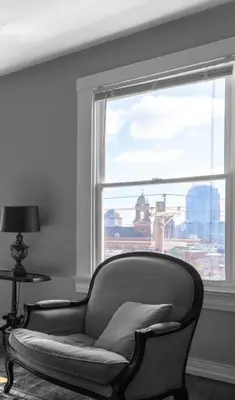 a chair in front of a window with a view at OTR Penthouse Walk Everywhere FREE Parking in Cincinnati