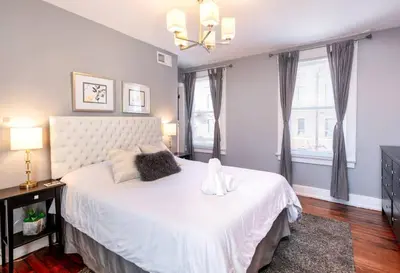 a bedroom with a large white bed and a window at OTR Penthouse Walk Everywhere FREE Parking in Cincinnati