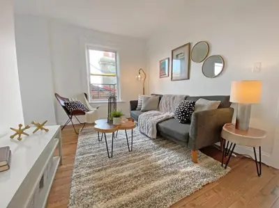 a living room with a couch and a table at Explore Downtown and Mount Adams with River Views in Cincinnati