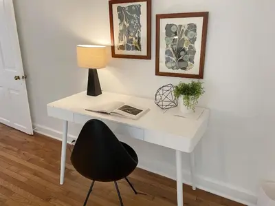 a white desk with a black chair and a lamp at Explore Downtown and Mount Adams with River Views in Cincinnati