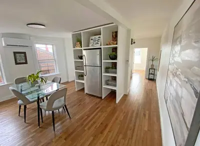 a kitchen and dining room with a table and a refrigerator at Explore Downtown and Mount Adams with River Views in Cincinnati