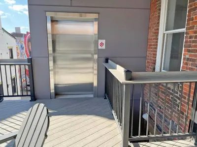 a door to a house with a bench on a porch at Over the Rhine Luxury MicroSuite On Findlay Market in Cincinnati