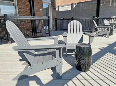 a group of chairs and a table on a deck at Over the Rhine Luxury MicroSuite On Findlay Market in Cincinnati