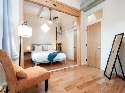 a bedroom with a bed and a chair at Cozy OTR Home with Private Roof Deck in Cincinnati