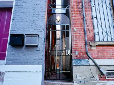 a building with a revolving door on the side of it at Cozy OTR Home with Private Roof Deck in Cincinnati