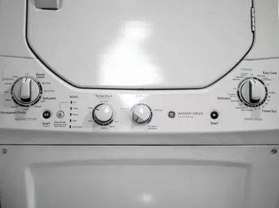 a close up of a washing machine with its knobs at Cozy OTR Home with Private Roof Deck in Cincinnati