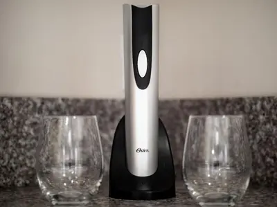 two empty wine glasses next to a black and white appliance at Cozy OTR Home with Private Roof Deck in Cincinnati
