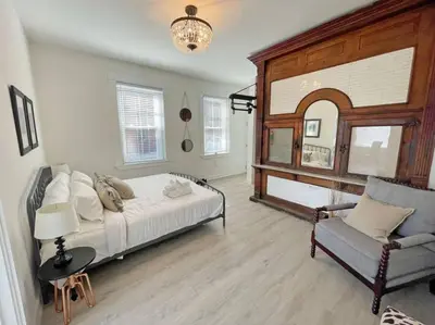 a bedroom with a bed and a chair at Full Building Huge Downtown Retreat Walkable to Everything in Cincinnati