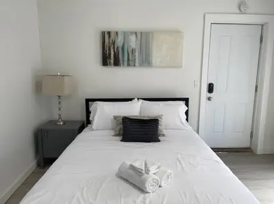 a white bed with two towels on top of it at Full Building Huge Downtown Retreat Walkable to Everything in Cincinnati