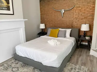a bedroom with a bed with a towel on it at Full Building Huge Downtown Retreat Walkable to Everything in Cincinnati