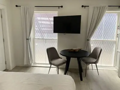 a bedroom with a table and two chairs and a tv at Cute Microapartment Walkable to Everything in Cincinnati