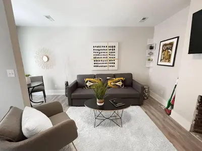 a living room with a couch and a table at Quiet 1-Bedroom Loft near Entertainment District in Cincinnati