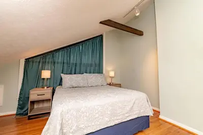 a bedroom with a bed and a large window at Mt Adams 1BR Great Location Steps from Monastery in Cincinnati