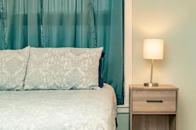 a bedroom with a bed and a night stand with a lamp at Mt Adams 1BR Great Location Steps from Monastery in Cincinnati