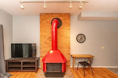 a red fireplace in a living room with a tv at Mt Adams 1BR Great Location Steps from Monastery in Cincinnati