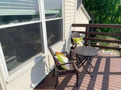 a patio with a table and a chair on a porch at Lovely 2bd in Mount Adams near Downtown and OTR in Cincinnati