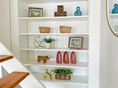 a staircase with white shelves with plants and vases at Lovely 2bd in Mount Adams near Downtown and OTR in Cincinnati