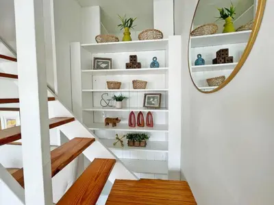 a staircase with white shelves and a mirror at Lovely 2bd in Mount Adams near Downtown and OTR in Cincinnati