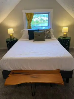 a bedroom with a large bed with a window at Lovely 2bd in Mount Adams near Downtown and OTR in Cincinnati