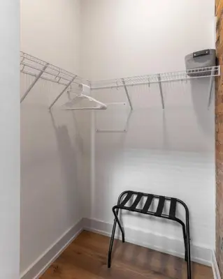 a black bench in a room with a white wall at WALK TO ALL in Over The Rhine Cincinnati in Cincinnati