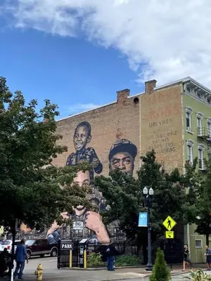 a mural of two men on the side of a building at WALK TO ALL in Over The Rhine Cincinnati in Cincinnati