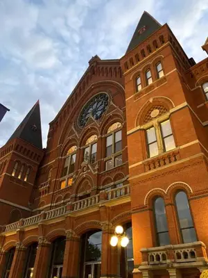 a large brick building with a clock on it at WALK TO ALL in Over The Rhine Cincinnati in Cincinnati
