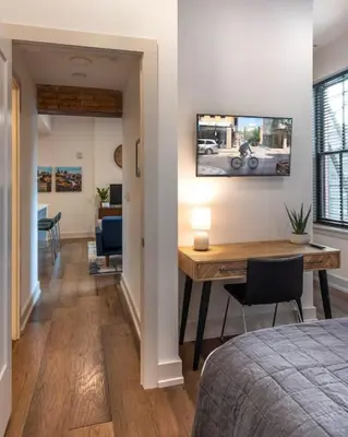a room with a desk and a dining room at WALK TO ALL in Over The Rhine Cincinnati in Cincinnati