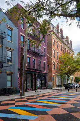 a city street with a painted sidewalk in front of buildings at WALK TO ALL in Over The Rhine Cincinnati in Cincinnati