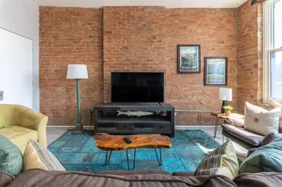 a living room with a couch and a tv at TRUTH Old world charm meets New world love in Cincinnati