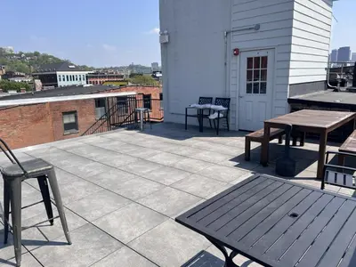 a patio with tables and benches on a building at TRUTH Old world charm meets New world love in Cincinnati