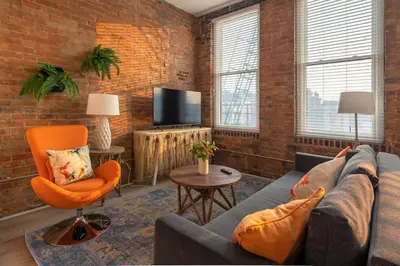 a living room with a couch and a chair at ZANGO Explore OTR and Downtown from a Renovated Condo in Cincinnati