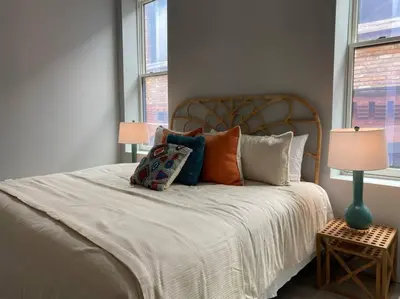 a bedroom with a large bed with pillows on it at ZANGO Explore OTR and Downtown from a Renovated Condo in Cincinnati