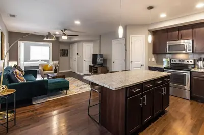 an open kitchen and living room with a couch at Stunning 2BR Apartment Near Downtown in Cincinnati