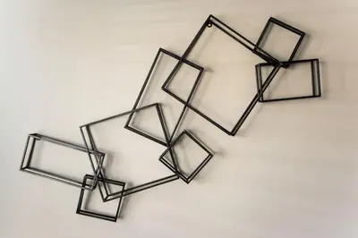 a group of four metal frames hanging on a wall at Stunning 2BR Apartment Near Downtown in Cincinnati