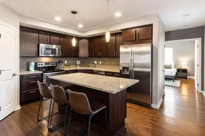 a large kitchen with a large island in the middle at Stunning 2BR Apartment Near Downtown in Cincinnati