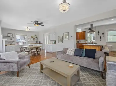 a living room with a couch and a table at Deluxe 6 Bedroom 3 Min to Downtown w 2-car Driveway in Cincinnati