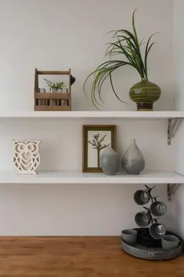 a shelf with vases and a potted plant on it at Deluxe 6 Bedroom 3 Min to Downtown w 2-car Driveway in Cincinnati