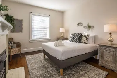 a bedroom with a large bed and a window at Deluxe 6 Bedroom 3 Min to Downtown w 2-car Driveway in Cincinnati